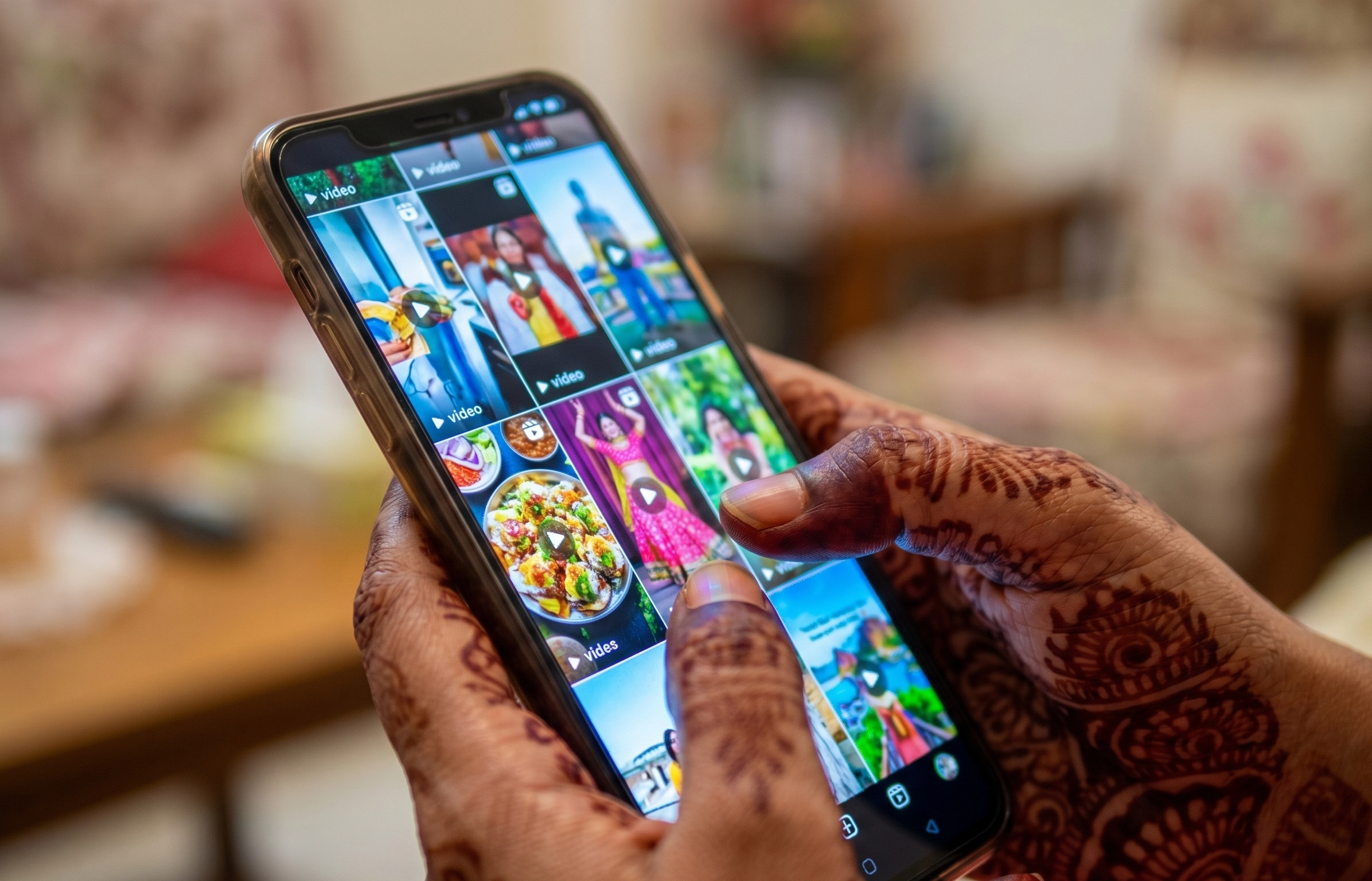 Indian hands scrolling social media feed showing how digital addiction in India is driven by platform algorithms