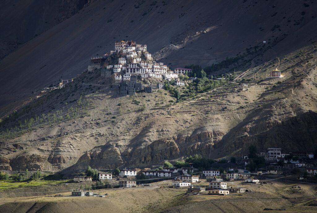 Key Monastery in Spiti Valley perched dramatically on a hilltop with prayer flags and Himalayan peaks