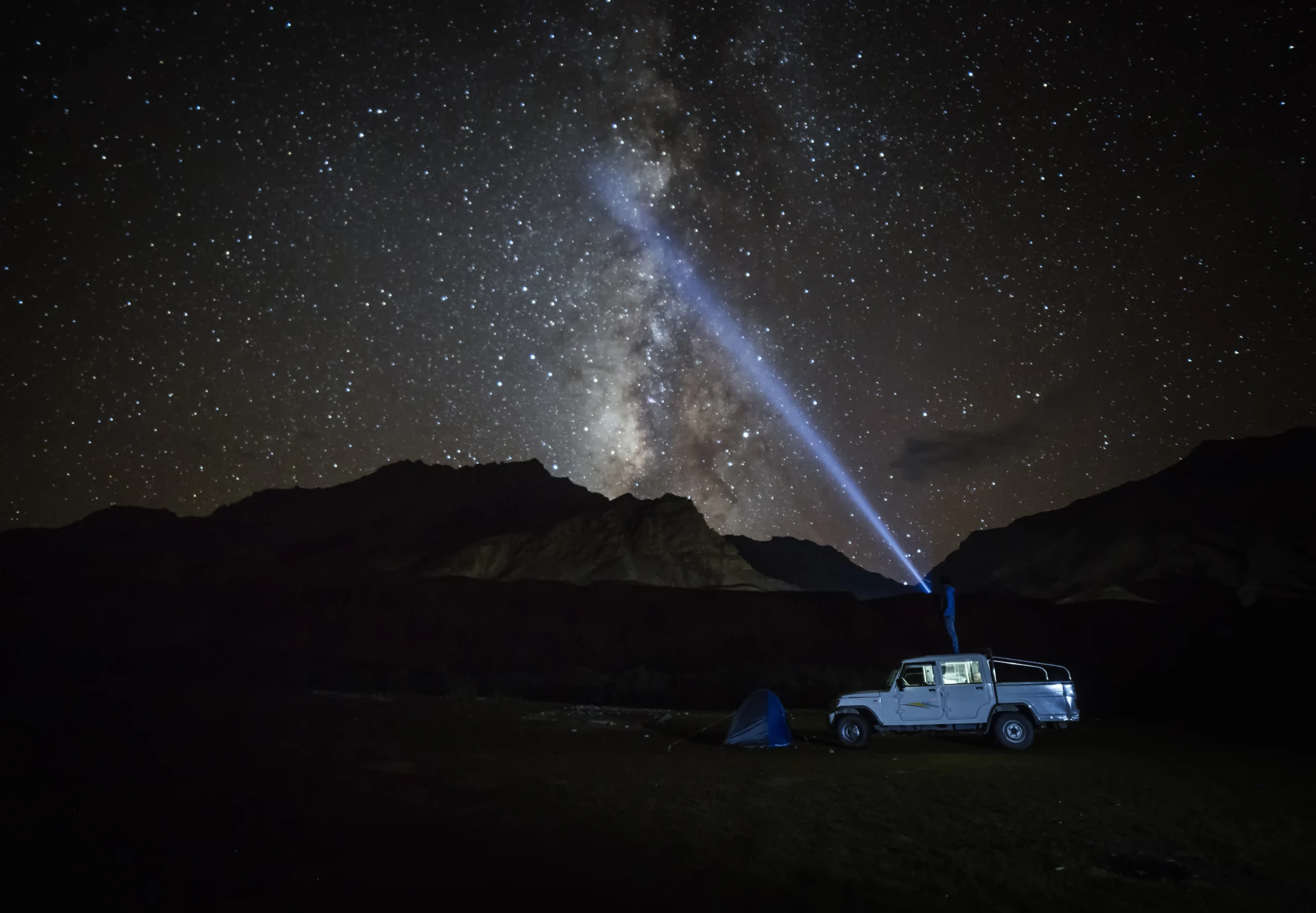 Photographer capturing Milky Way photography India over snow-capped Spiti Valley peaks at night