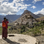 Key Monastery in Spiti Valley perched dramatically on a hilltop with prayer flags and Himalayan peaks
