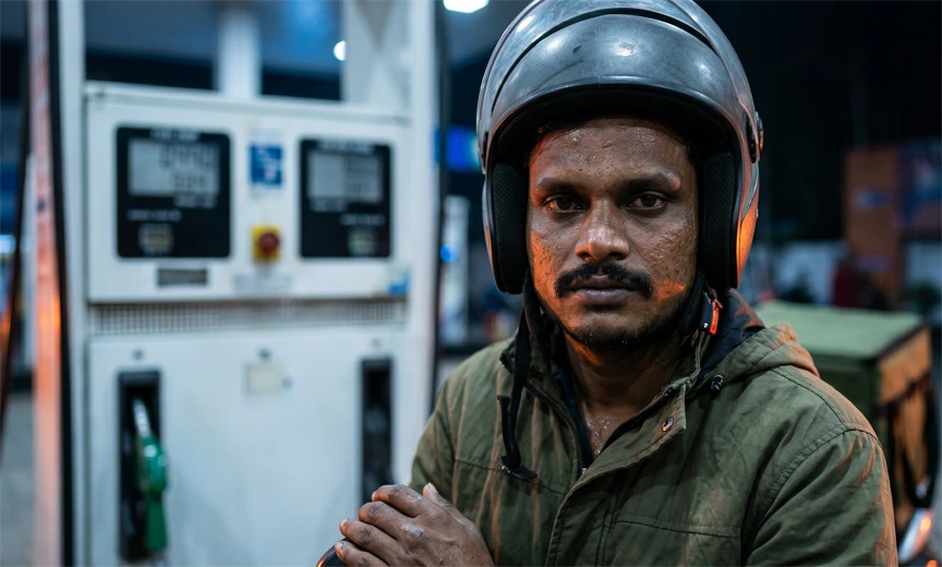 Indian gig economy worker filling petrol representing hidden income costs for platform workers in India 2026