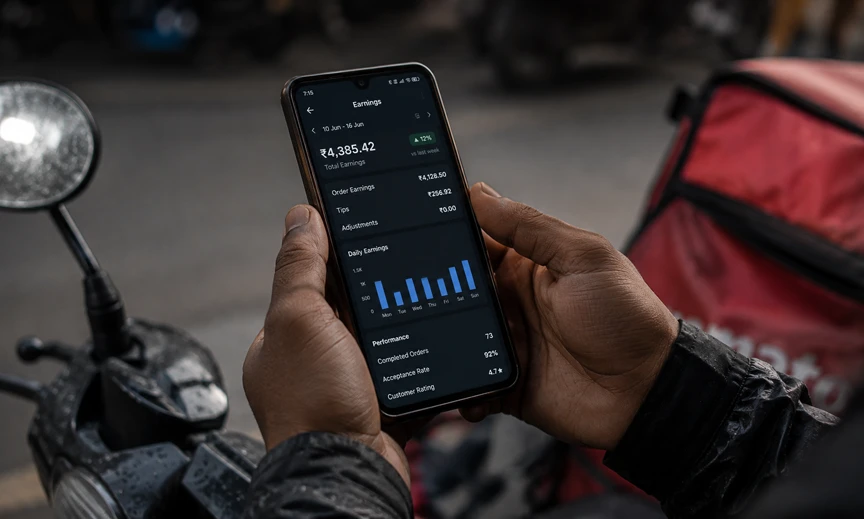 Indian gig worker checking delivery app earnings showing the algorithmic control in India's gig economy 2026